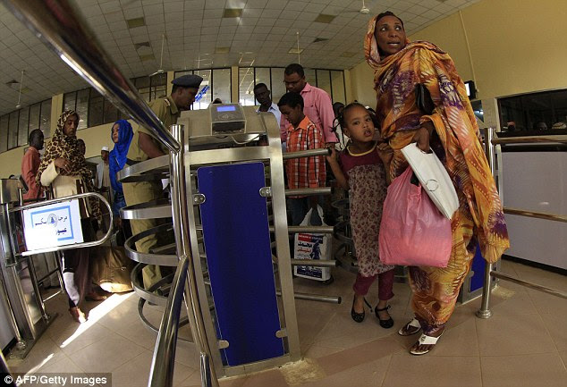 Modern system: Sudanese passengers pass through the gates on the platform of Sudan's new Nile Train