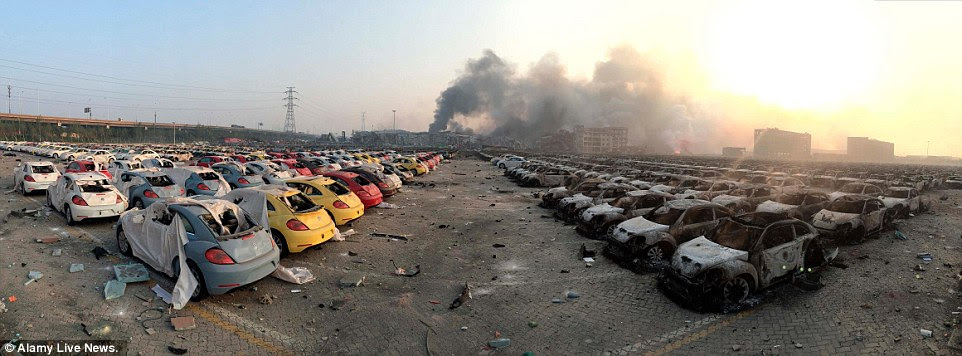 The enormous fireballs from the blasts rolled through a nearby parking lot, turning a fleet of 1,000 new cars into scorched metal husks
