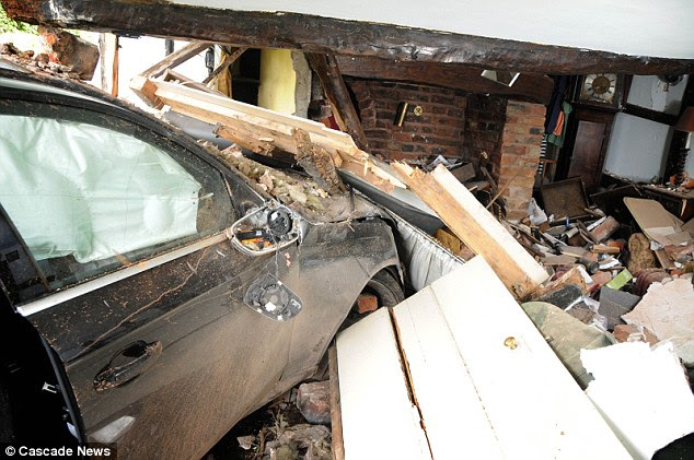 No injuries: The driver of the Audi - worth £55,000 - and the couple's three cocker spaniels were unhurt