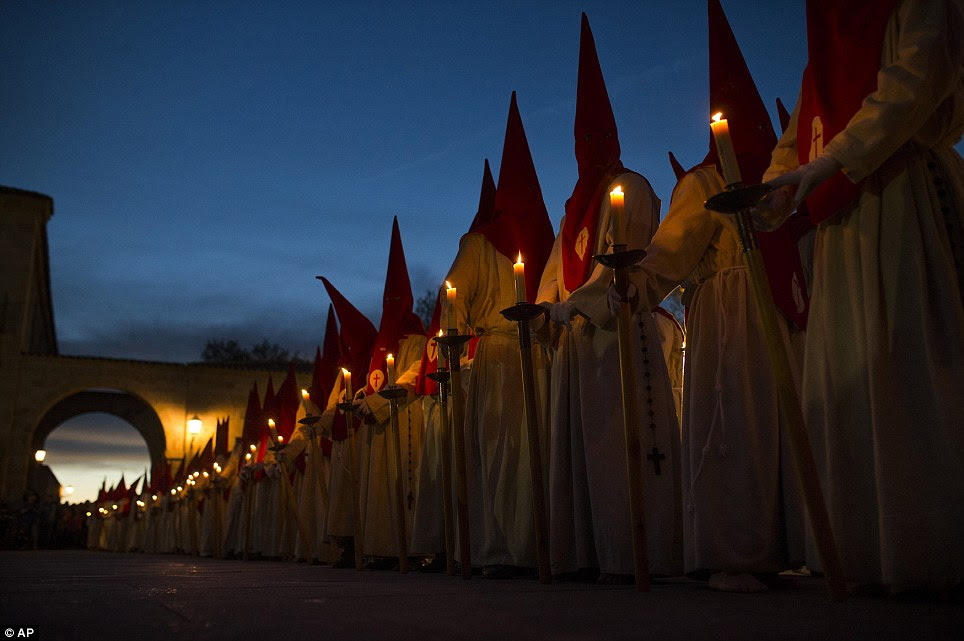 Uniform: The fraternity is identifiable only by the colour of its hood and dress - which shows the badge of the brotherhood on their chests