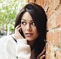 A stock photo of a young woman speaking on a mobile phone.