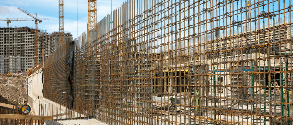 Photo description: Stock photo ID: 488632696 Construction site. Reinforced concrete basement of high-rise residental building. Concrete pouring, metal frame piles, steel rods, tower cranes