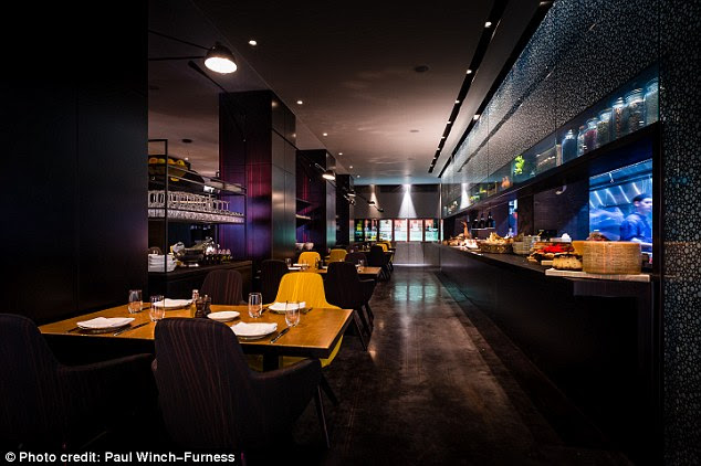At breakfast, the setting is much the same as at dinner, polished black surfaces, a roaring fire and candles