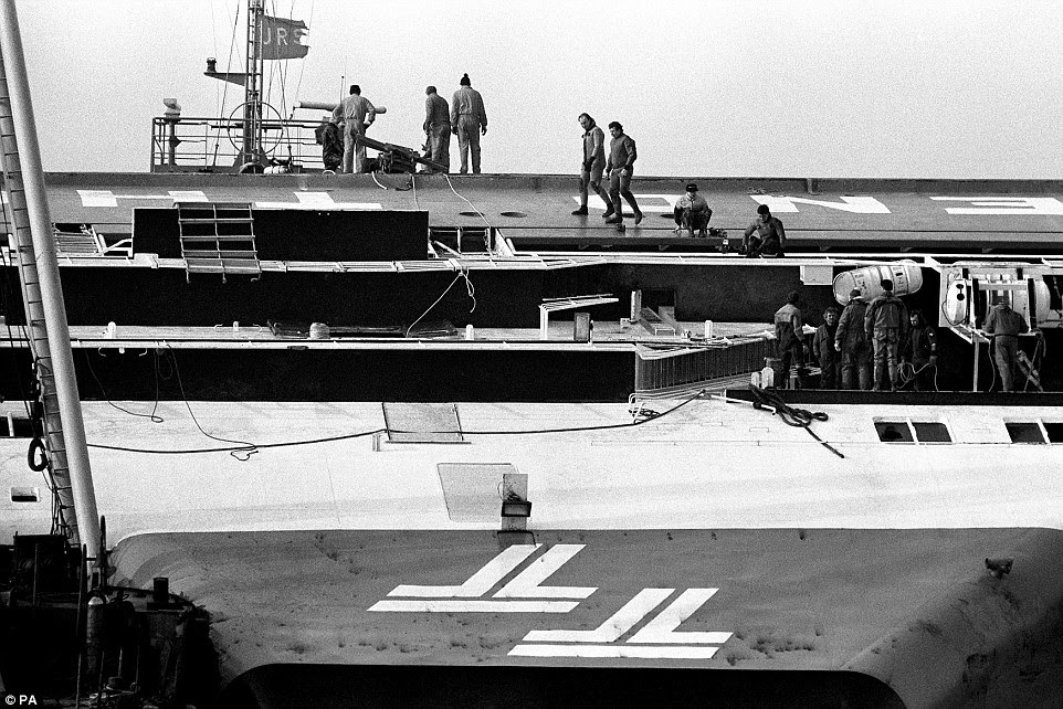 The 13,600 tonne boat was on its way to Dover when the catastrophe occurred. Pictured are rescue workers on the side of the ship on March 7 