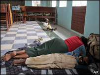 A child plays as people sleep inside a church in Thika, on the outskirts of Nairobi