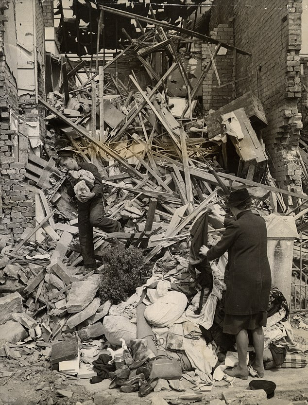 Fragments: A sailor lends a hand in recovering belongings from a house in Bath during the Baedeker Blitz