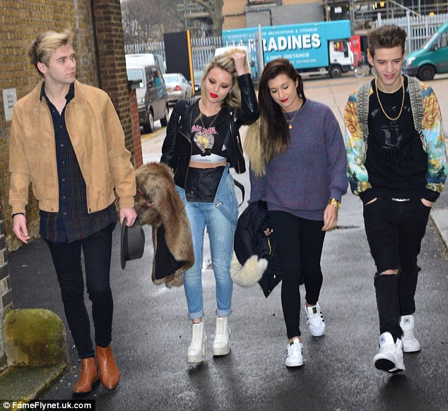All together now: The band's boys, Mikey Bromley (far left) and Charlie George (far right) caught up with them
