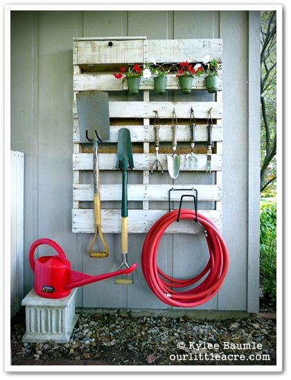 Transform a pallet into a garden tool storage area. Source