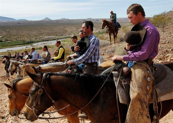 Jason Bean / AP (Bundy Ranch protesters observe the National Anthem.)