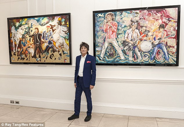How much?! Ronnie posed next to just tow of hi paintings as he revealed the expensive items for the viewing public for the first time
