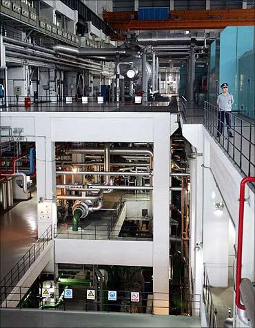A Chinese security personnel guards the entrance to the nuclear power plant in Qinshan.