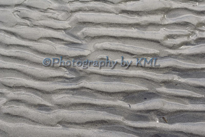 wet sand ripples at the ocean