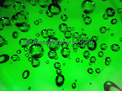 macro od bubles in a green glass globe