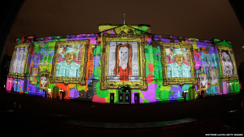 Self portraits by children projected onto Buckingham Palace