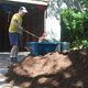 Truckload of mulch on a driveway