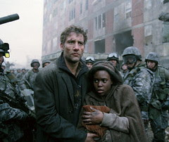 Theo and Kee (Claire-Hope Ashitey) maneuver through the destruction
