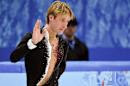 Evgeni Plushenko of Russia, waves as he leaves the ice after withdrawing from the men's figure skating competition due to illness at the Iceberg Skating Palace during the 2014 Winter Olympics, Thursday, Feb. 13, 2014, in Sochi, Russia. (AP Photo/The Canadian Press, Paul Chiasson)