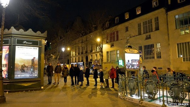 Customers wait in line at Pigalle newsstand, where the new edition of Charlie Hebdo magazine is being sold 