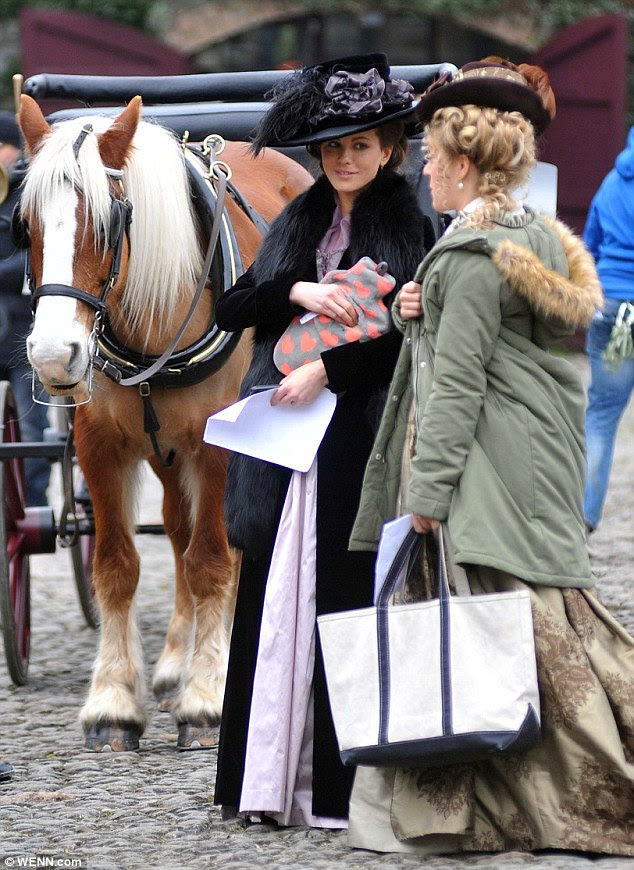 Gee up: The two co-stars chatted close to a horse and carriage, with Kate appearing to clutch a page from the shooting script 