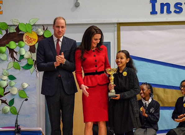 Kate Middleton wore Luisa Spagnoli red suit, Gianvito Rossi black suede pumps, Mulberry suede clutch, Mappin & Webb earrings. Place2Be