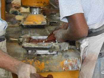 The colored cement is hand-poured into the different sections of the molds.