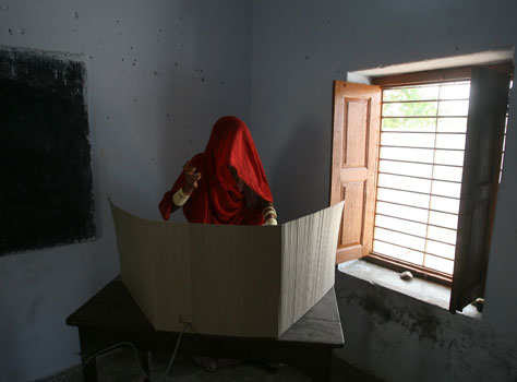 A woman casts her vote