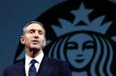FILE - In this March 20, 2013 file photo, Starbucks CEO Howard Schultz speaks at the company's annual shareholders meeting, in Seattle, Wash. Schultz is collaborating on a book about veterans of the wars in Iraq and Afghanistan. “For Love of Country: What Our Veterans Can Teach Us About Citizenship, Heroism, and Sacrifice” will be published by Alfred A. Knopf on Nov. 4. The book will be co-written by Washington Post correspondent and editor Rajiv Chandrasekaran. According to Knopf, which announced the book Monday, a “majority” of author proceeds will be donated to veteran services organizations. (AP Photo/Ted S. Warren, File)