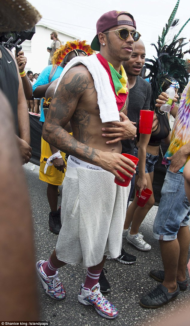 Hamilton walks around topless at the annual Kadooment Day event on Monday