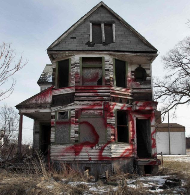 Ghost town: A vacant and blighted home, covered with red spray paint, sits alone in an east side neighborhood once full of homes in Detroit