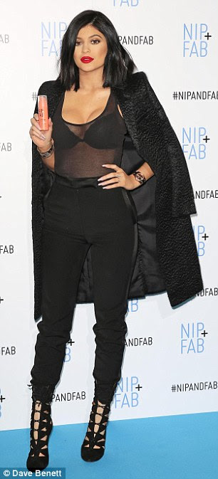 City chic: Wearing head-to-toe black, Kylie stood tall in an envy-inducing pair of strappy heels as she draped a long blazer jacket over her shoulders