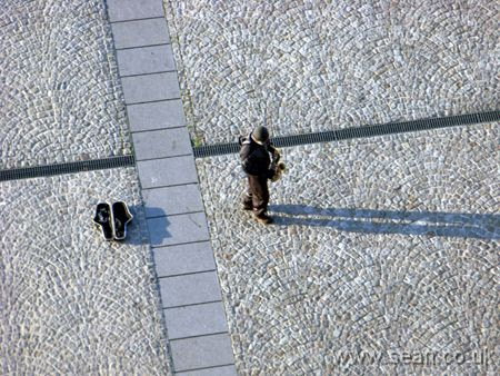 Photo of a saxophonist busking by the Pompidou Centre