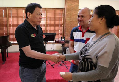President Duterte greets the parents of the 17-year-old killed by the police.