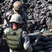 Army and Navy technicians prepare unexploded ordnance for demolition in 2003 near Baghdad.