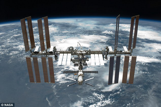Nasa mission controllers in Texas have moved the ISS (shown) using the European ATV-5 cargo spacecraft (seen at the bottom middle of the picture) to avoid a collision. They increased the speed of the station by 16ft (5 meters) per second. This raised the height of the station by one mile (1.6km)