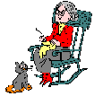woman in rocking chair knitting with cat
