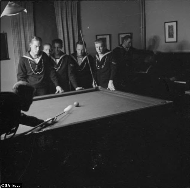 At play: Finnish sailors relax together at the snooker tablep an online archive of their own, showcasing almost 160,000 wartime photos from Finland during WWII