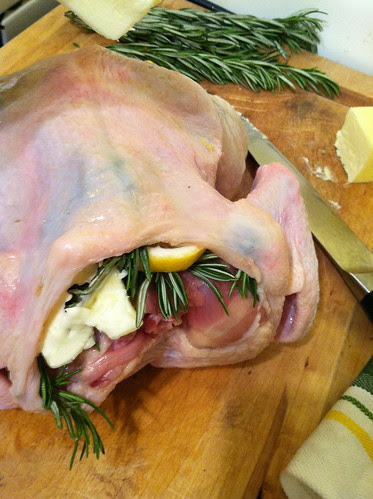 Chicken is stuffed under the skin with butter, rosemary, lemon, salt and pepper 