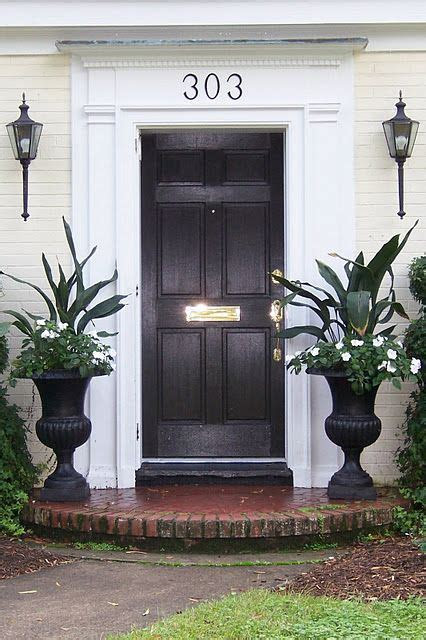 The cape cod line of planters continues a tradition of high quality well designed products developed to last and provide its owners with years of enjoyment and . Black door and planters | Front door planters, Front porch