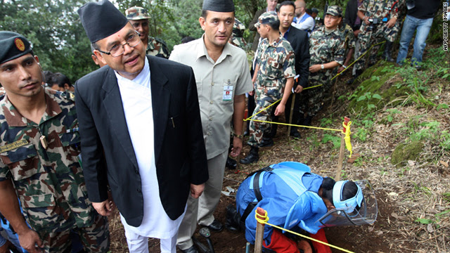 Nepalese PM Jhala Nath Khanal, second from left, observes an army deminer outside Kathmandu on Tuesday.
