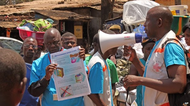 Health workers teach people about the Ebola virus and how to prevent infection, in Conakry, Guinea - 31 March  2014