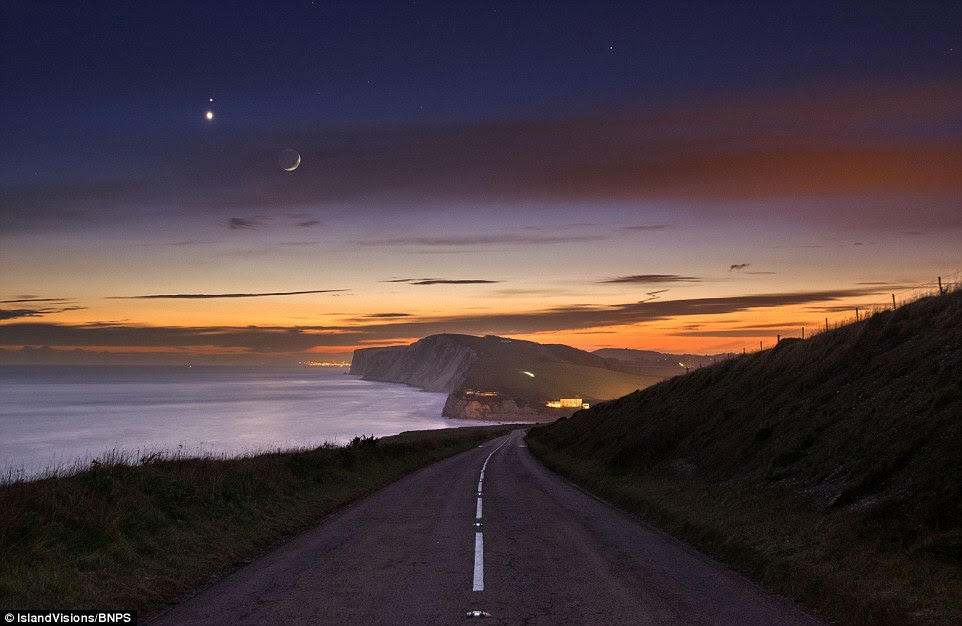 Stunning scene: The red dot of Mars just above the brighter Venus, with the moon to the right on the Isle of Wight