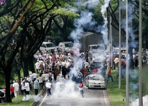 Protesters run away as Malaysian riot police fire tear gas during a protest against using English for mathematics and science teaching in Kuala Lumpur, Malaysia, Saturday, March 7, 2009. AP Photo