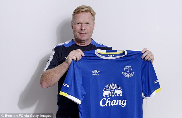 Ronald Koeman  holding the Everton shirt after being announced as the club's new manager