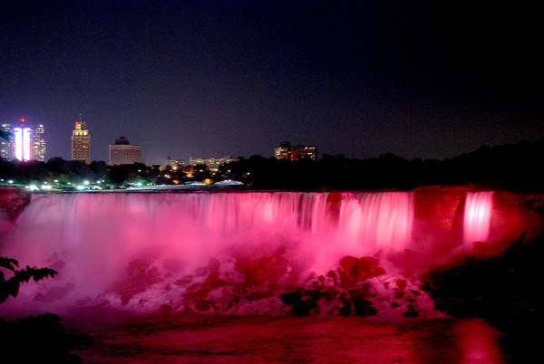 The American Falls take on a red glow during the nightly illumination.