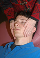 Practitioners' hands on head Practitioners' hands on head