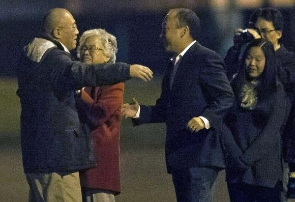 Kenneth Bae (L) reunites with his family at U.S. Air Force Joint Base Lewis-McChord in Fort Lewis, Washington November 8, 2014.    REUTERS/David Ryder