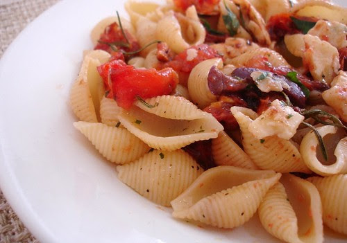 Pasta with tomatoes, olives, grana padano and basil