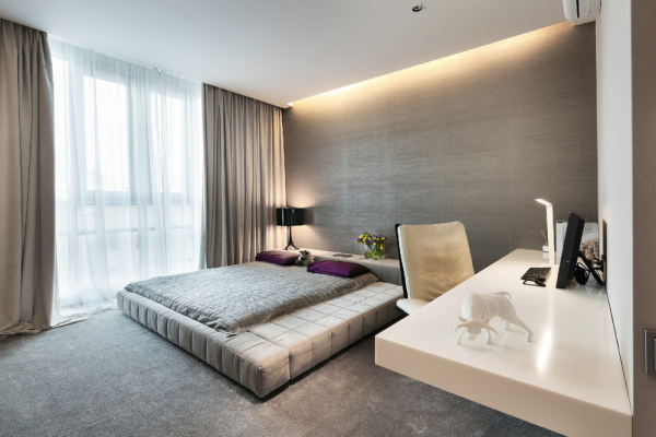 A soft platform bed and gauzy curtains make this bedroom soft and feminine.