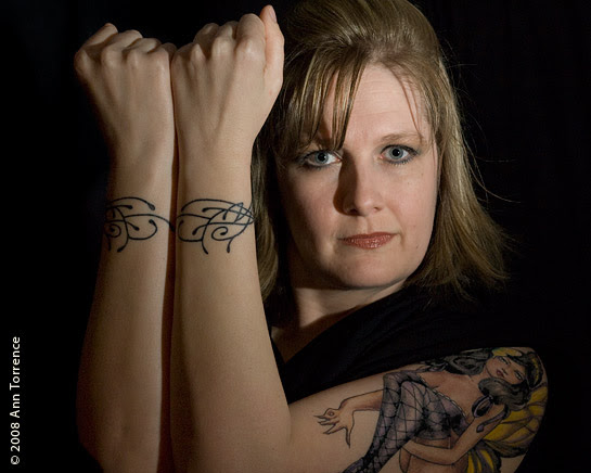 blonde woman with tattoo bracelet. Monica