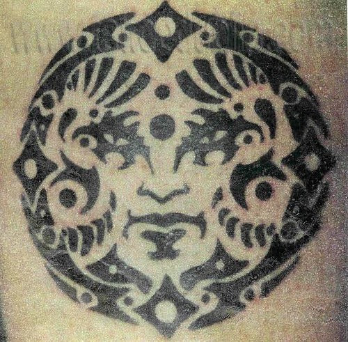 black tribal moon face tattoo by dublin ireland tattoo artist 'Pluto'